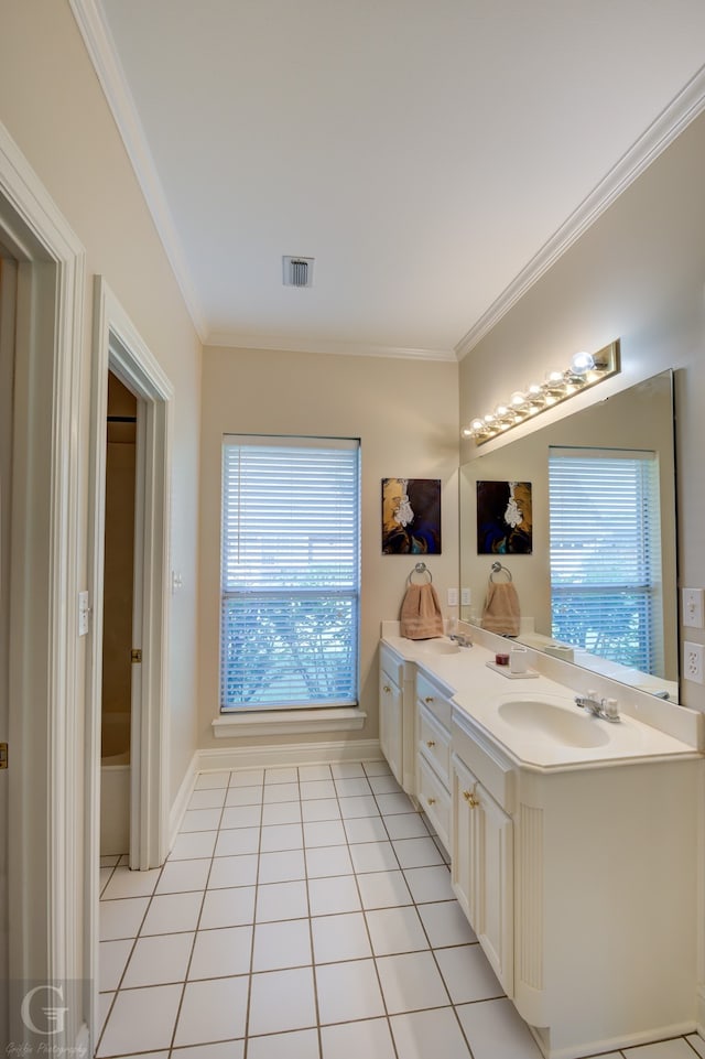 bathroom featuring tile patterned flooring, vanity, and crown molding