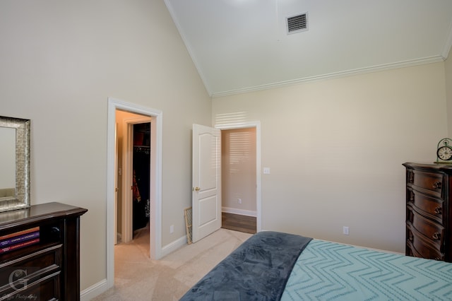 carpeted bedroom with crown molding, a spacious closet, a closet, and high vaulted ceiling