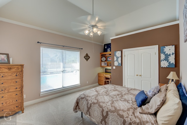 carpeted bedroom featuring ceiling fan, a closet, ornamental molding, and lofted ceiling