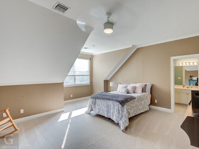 bedroom with ornamental molding, ceiling fan, ensuite bathroom, and light carpet