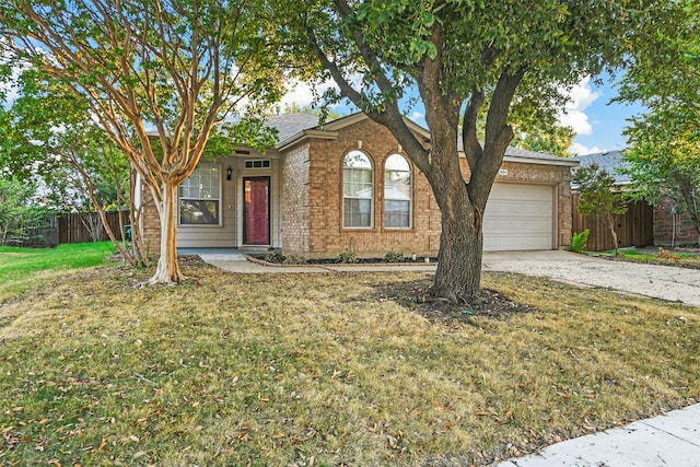 view of front of home with a garage and a front lawn