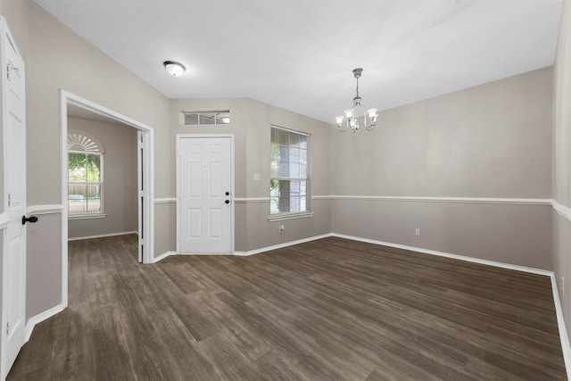 interior space featuring dark hardwood / wood-style floors and a chandelier