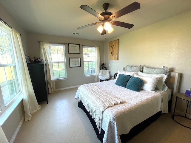 bedroom with multiple windows and ceiling fan