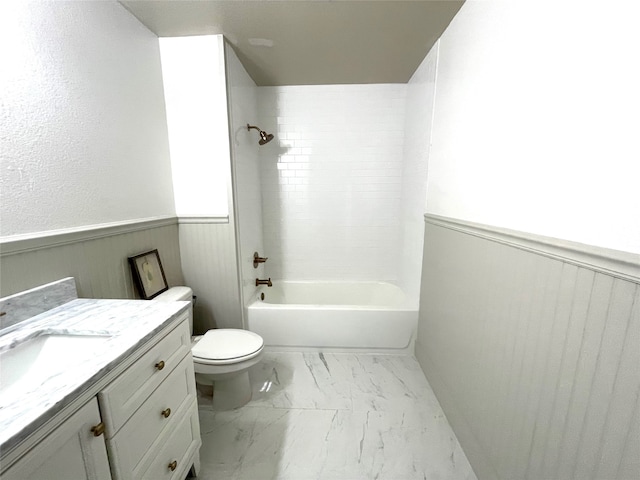 full bathroom with tiled shower / bath combo, vanity, and toilet