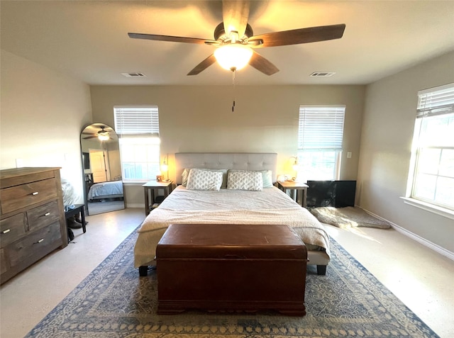 bedroom featuring multiple windows and ceiling fan