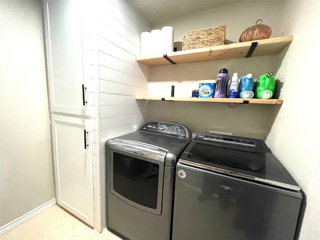 laundry room with washing machine and dryer and cabinets