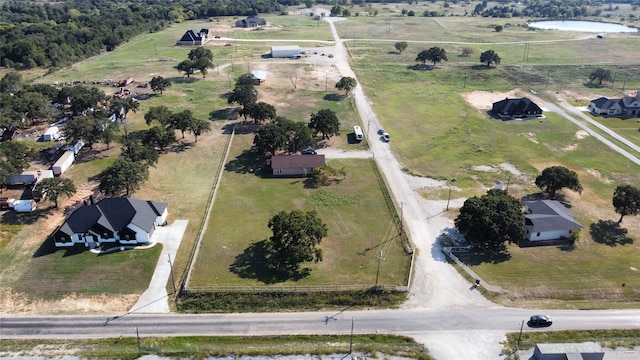 birds eye view of property with a rural view and a water view