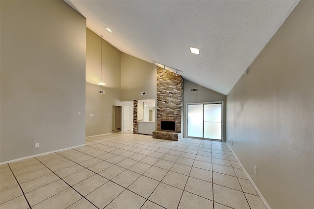 unfurnished living room featuring high vaulted ceiling, a large fireplace, a textured ceiling, and light tile patterned floors