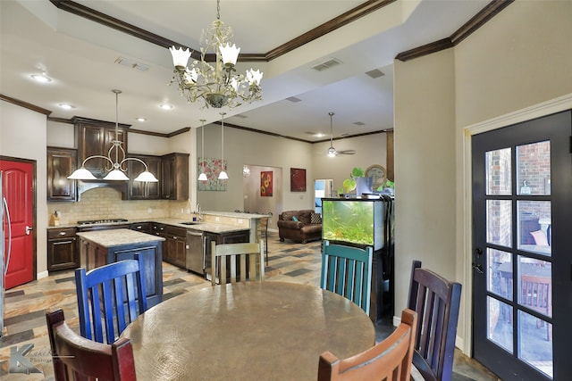 dining area featuring ceiling fan with notable chandelier, crown molding, and sink