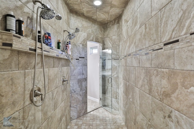 bathroom featuring a shower with shower door