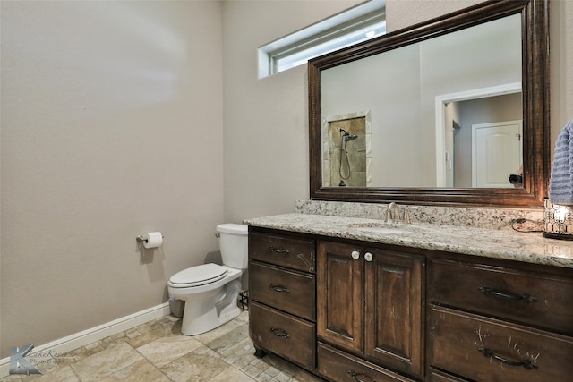 bathroom featuring walk in shower, vanity, and toilet