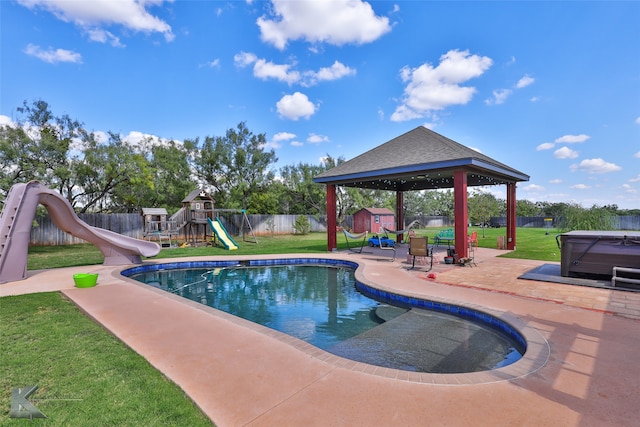 view of swimming pool with a gazebo, a playground, a water slide, and a lawn