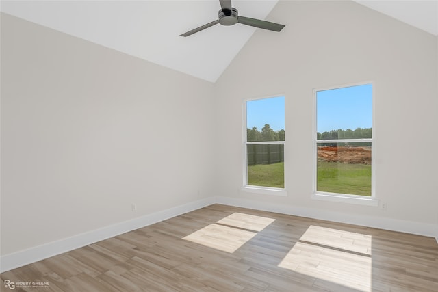 empty room with ceiling fan, light wood-type flooring, and high vaulted ceiling