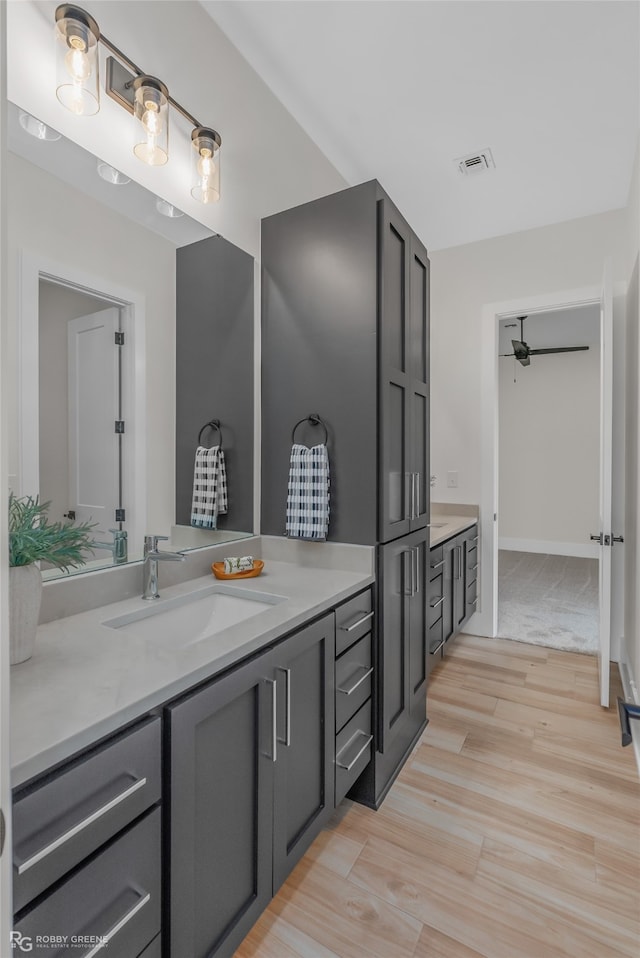 bathroom with ceiling fan, hardwood / wood-style flooring, and vanity