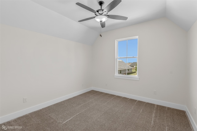 carpeted empty room with ceiling fan and lofted ceiling