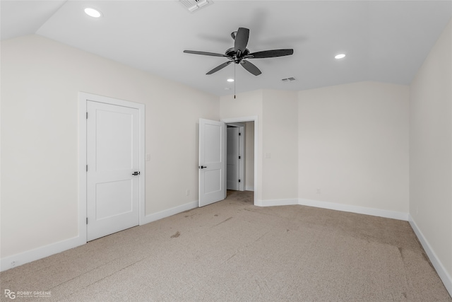 unfurnished bedroom with light carpet, lofted ceiling, and ceiling fan