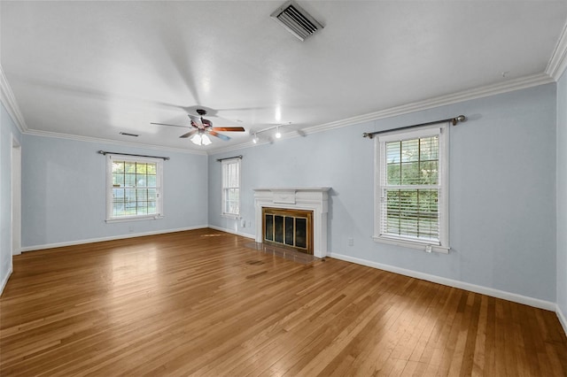 unfurnished living room with light hardwood / wood-style flooring, plenty of natural light, crown molding, and ceiling fan