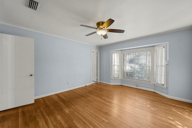 spare room featuring ceiling fan, light hardwood / wood-style flooring, and ornamental molding