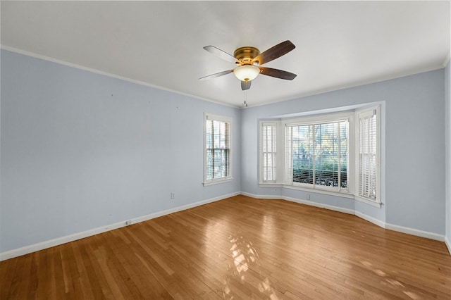 unfurnished room with light hardwood / wood-style flooring, ceiling fan, and ornamental molding