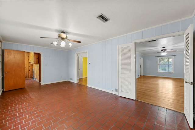 spare room with ceiling fan and ornamental molding