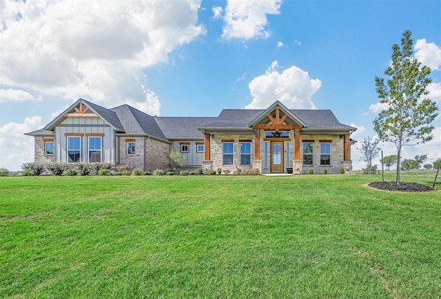 view of front of property with roof with shingles, board and batten siding, and a front yard