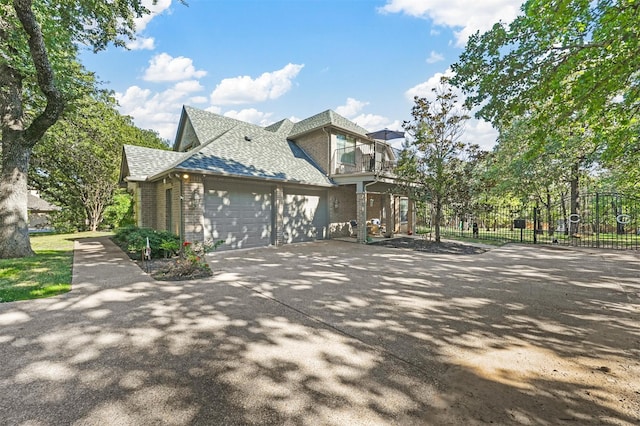 view of side of property with a balcony and a garage