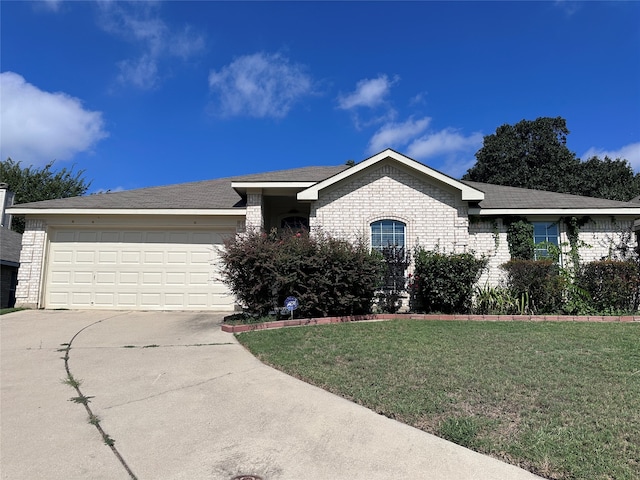 view of front of home featuring a front yard and a garage