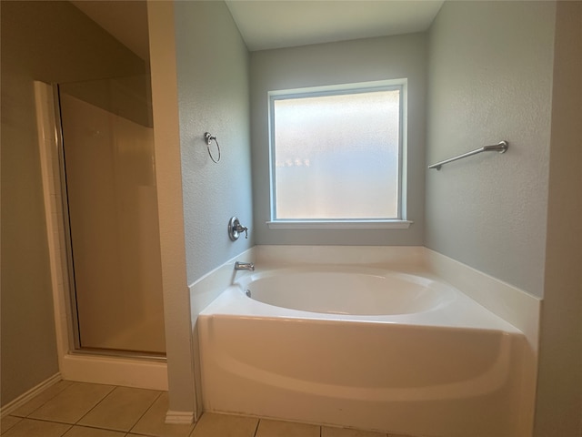 bathroom featuring plus walk in shower and tile patterned flooring