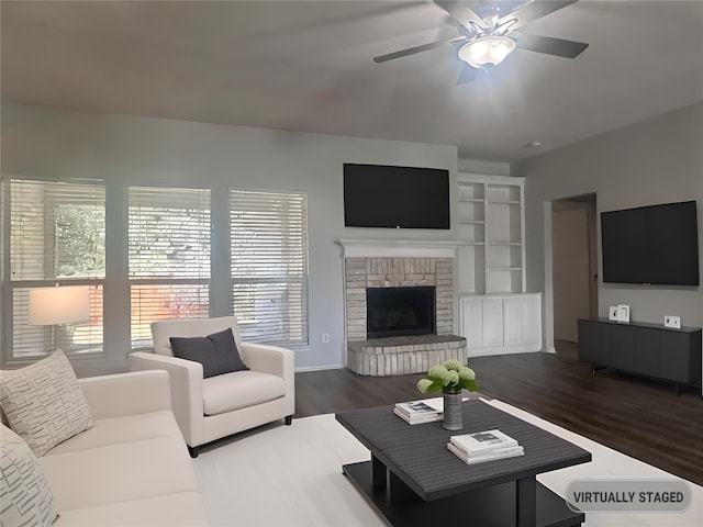 living room featuring a fireplace, ceiling fan, and dark hardwood / wood-style floors