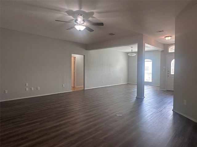 unfurnished room featuring dark wood-type flooring and ceiling fan