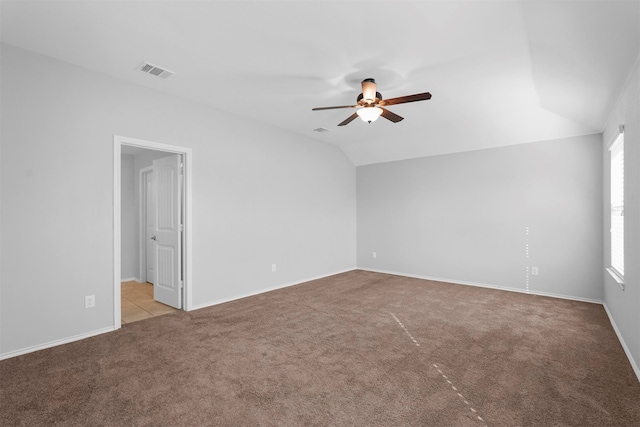 unfurnished room with ceiling fan, light colored carpet, and lofted ceiling