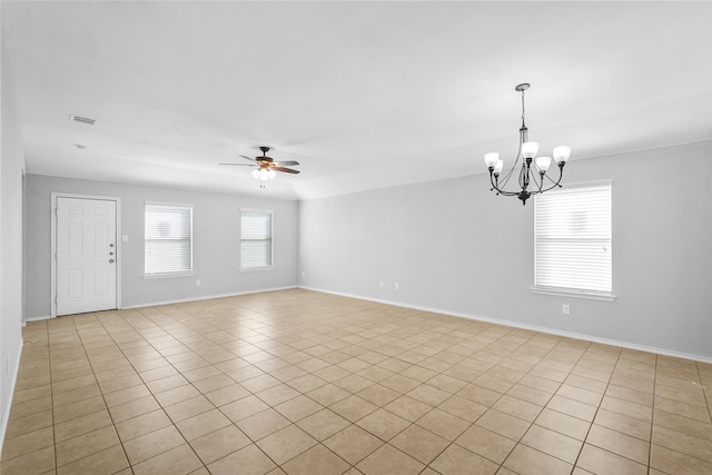 tiled empty room with ceiling fan with notable chandelier