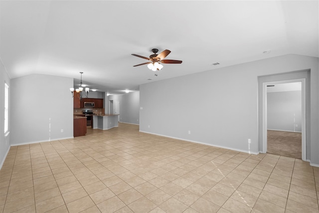 unfurnished living room featuring ceiling fan with notable chandelier, vaulted ceiling, and light tile patterned floors