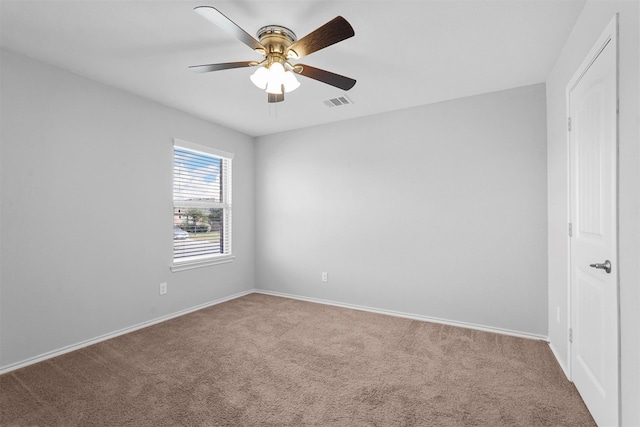 spare room with ceiling fan and carpet flooring