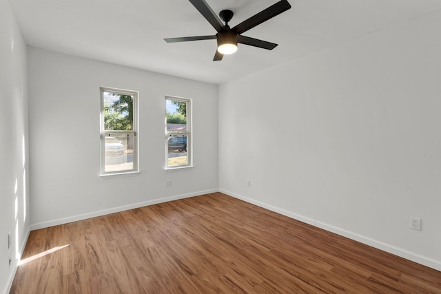 spare room with ceiling fan and light wood-type flooring