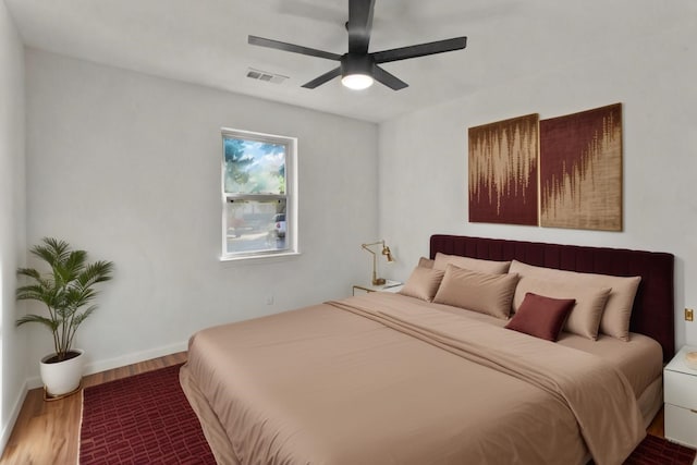 bedroom with hardwood / wood-style floors and ceiling fan