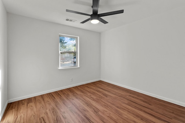 spare room featuring hardwood / wood-style flooring and ceiling fan