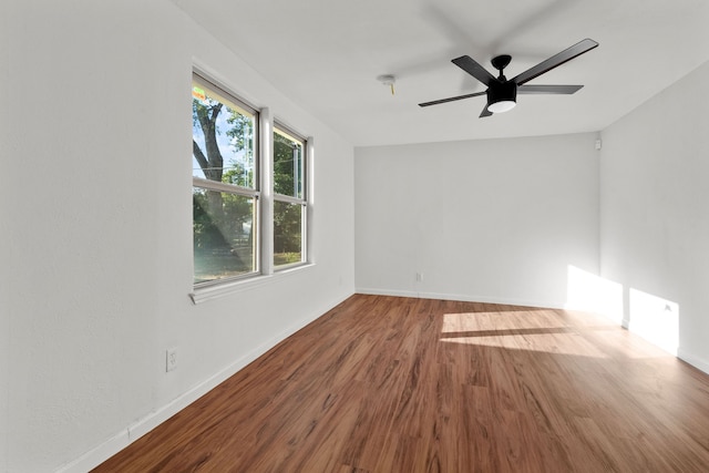 empty room featuring hardwood / wood-style flooring and ceiling fan