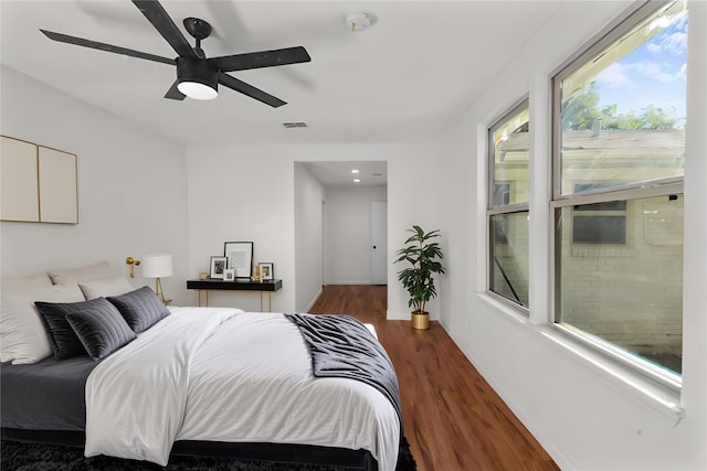 bedroom featuring ceiling fan and dark wood-type flooring