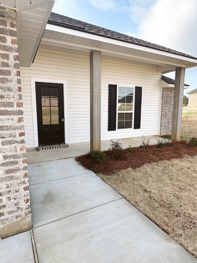 5793 Bunker Way, Blanchard, LA 71107 - view of exterior entry featuring covered porch, brick siding, and roof with shingles