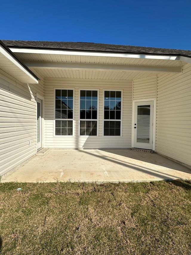 doorway to property featuring a yard and a patio