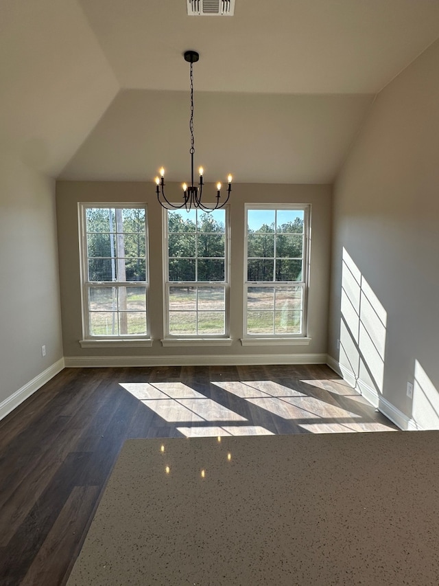 unfurnished dining area with a chandelier, dark wood-type flooring, and lofted ceiling