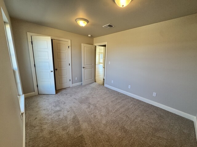 5793 Bunker Way, Blanchard, LA 71107 - unfurnished bedroom featuring carpet floors, a closet, visible vents, and baseboards