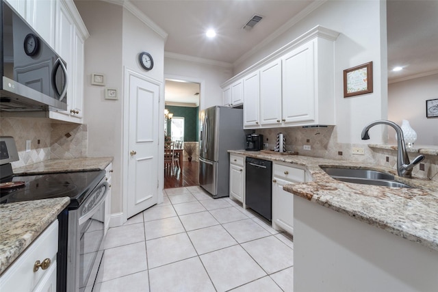 kitchen with light stone counters, stainless steel appliances, crown molding, sink, and white cabinets