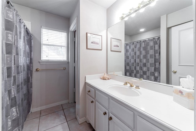 bathroom featuring tile patterned flooring, vanity, and walk in shower