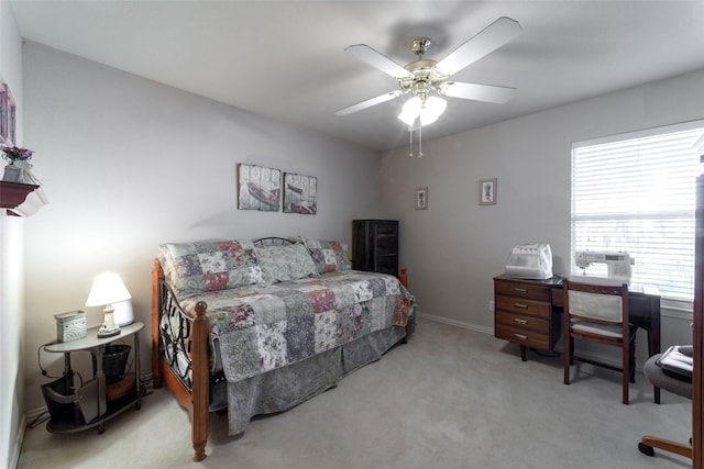 bedroom featuring light carpet and ceiling fan