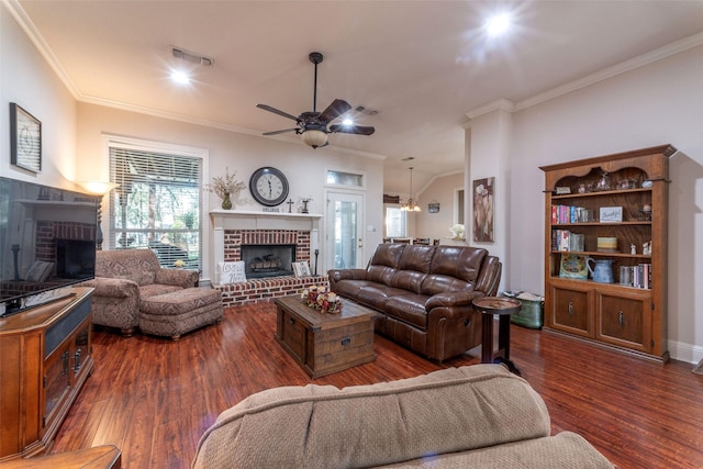 living room featuring dark hardwood / wood-style flooring, crown molding, a fireplace, and ceiling fan