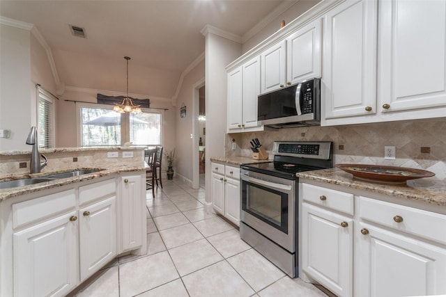 kitchen featuring white cabinetry, sink, hanging light fixtures, an inviting chandelier, and appliances with stainless steel finishes