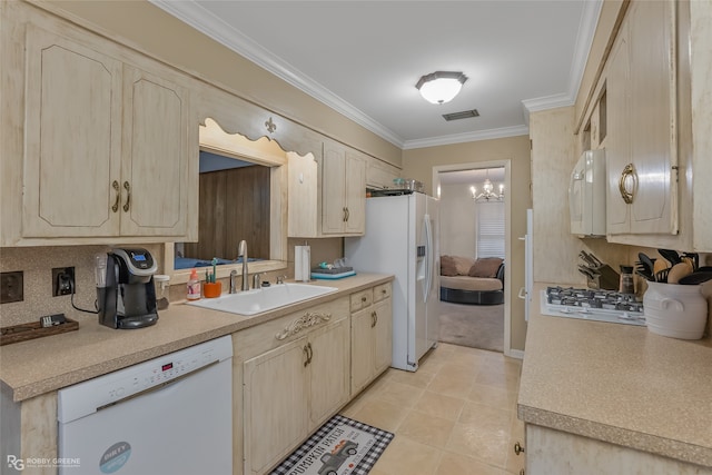 kitchen featuring sink, white appliances, light brown cabinetry, an inviting chandelier, and crown molding