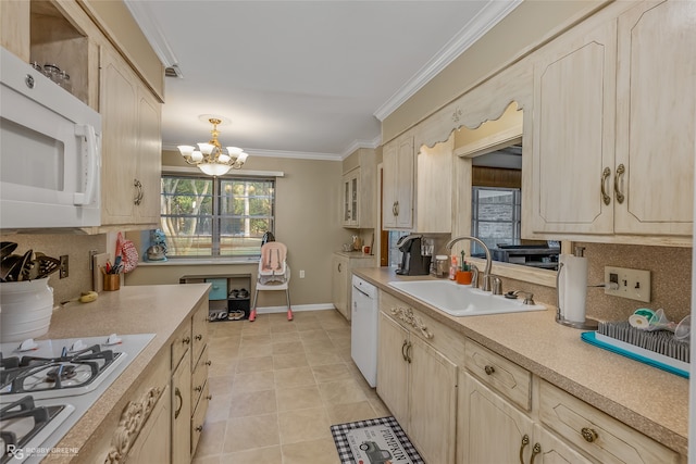 kitchen with a notable chandelier, white appliances, sink, and light brown cabinets